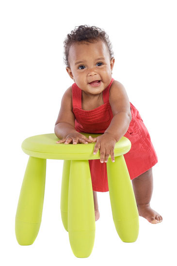 toddler playing with a chair